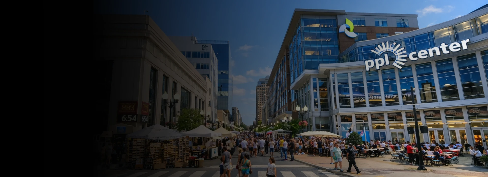 Busy outdoor pedestrian street event in front of PPL Center arena in Allentown, Pennsylvania on a sunny day